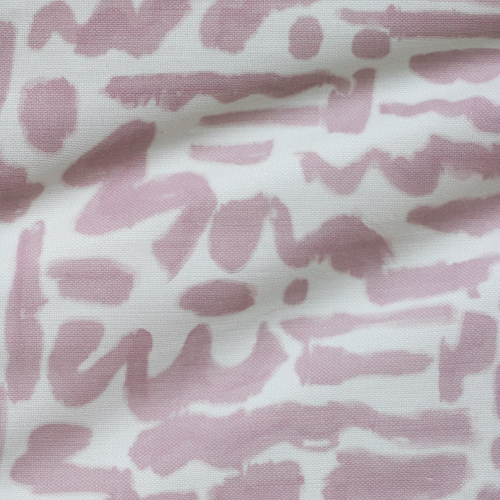 A fabric with a pink animal-like pattern on a white background, likely a part of the 'Doodles // Rose' product.