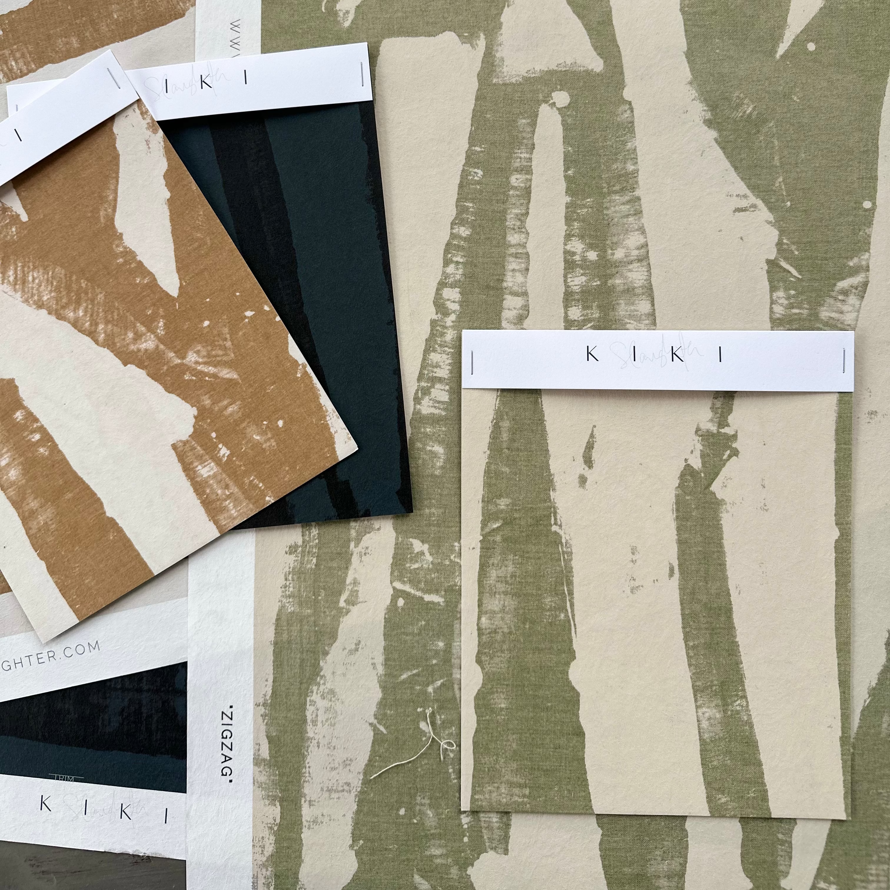 KIKI brand samples of fabric with abstract patterns on a neutral background