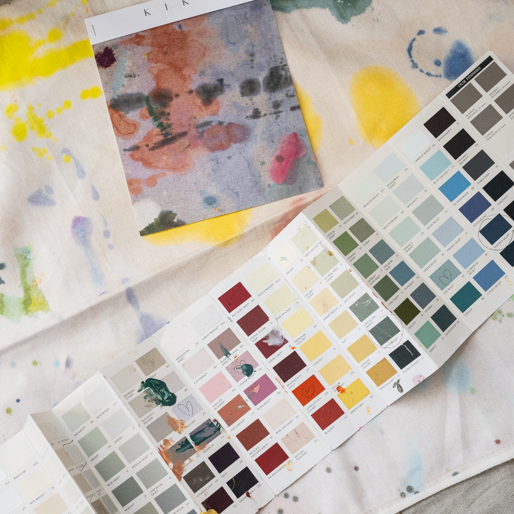 Color swatches and watercolor samples on a textured surface