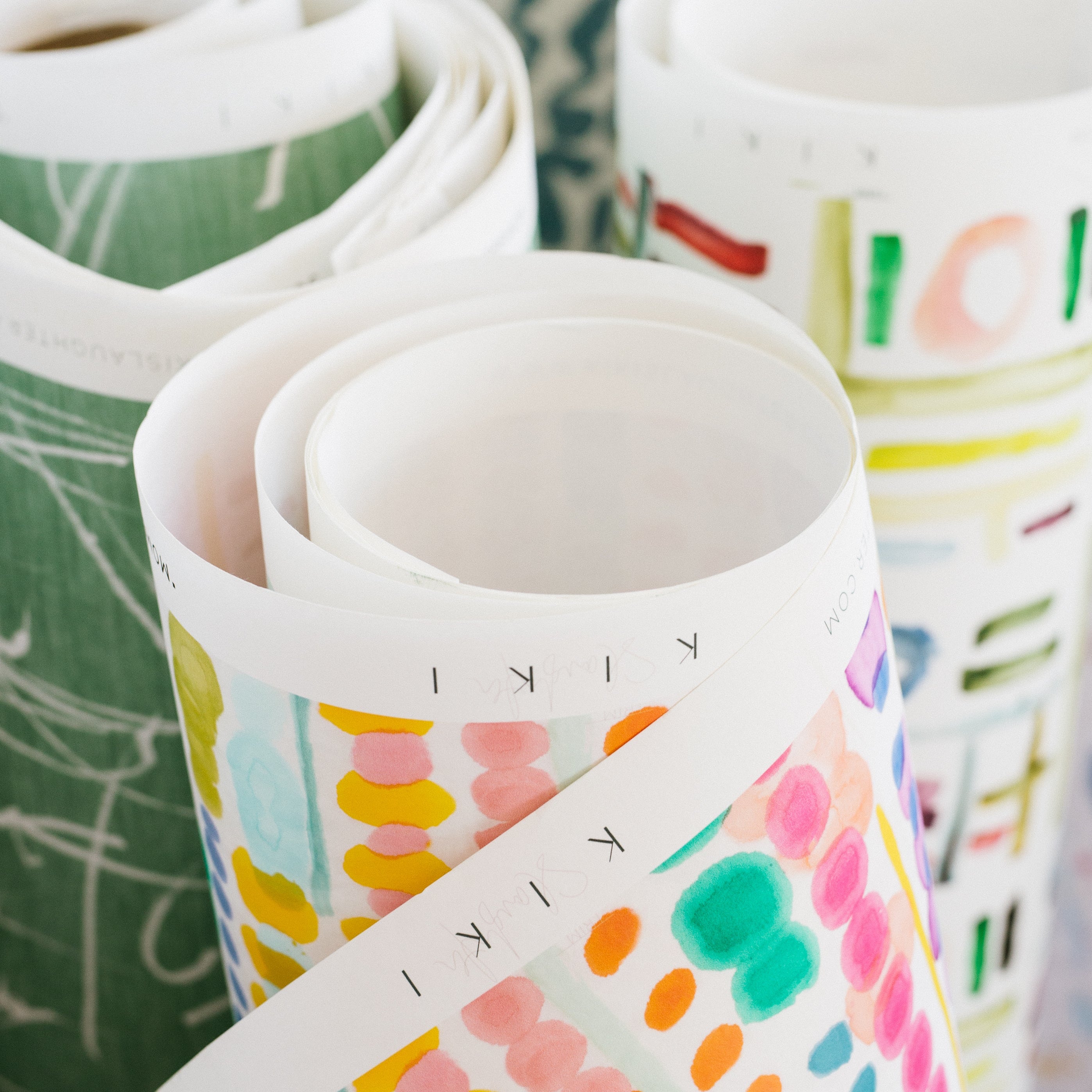 Rolls of colorful fabric with patterns in a basket